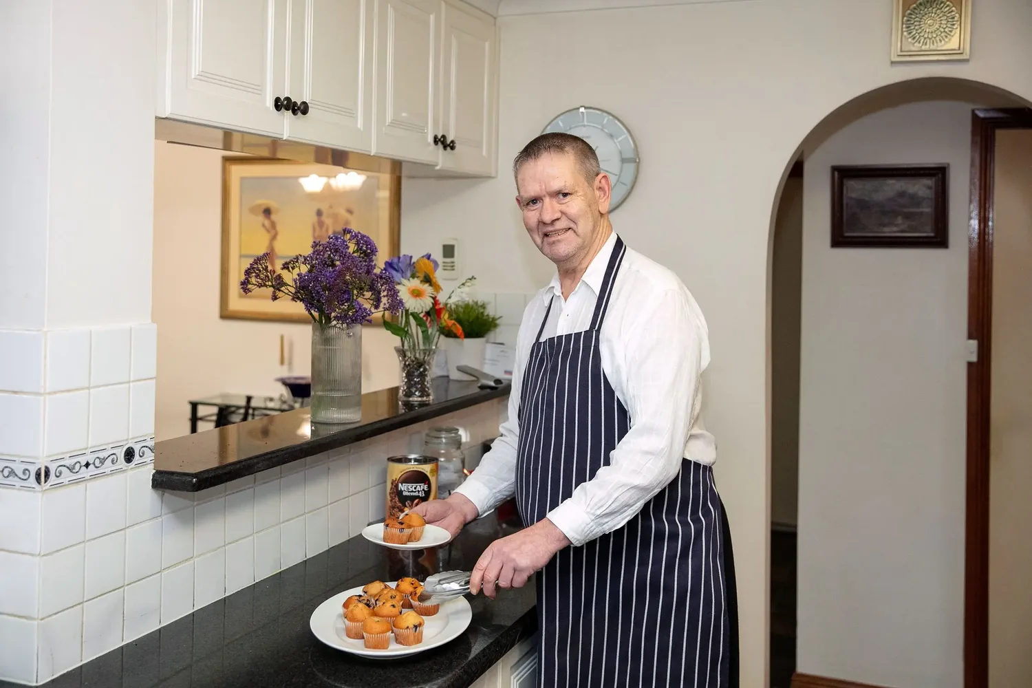 A participant preparing food in his kitchen
